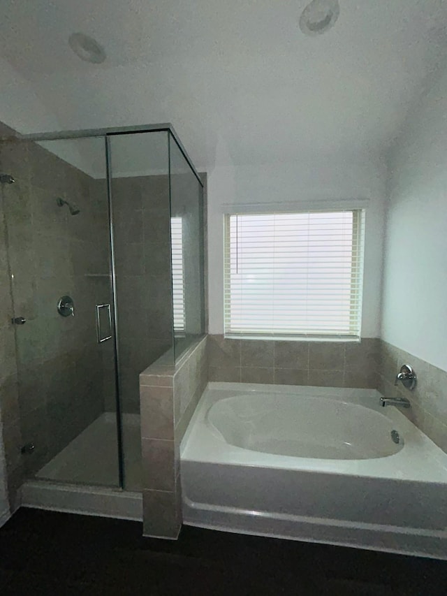 bathroom featuring a garden tub and a stall shower