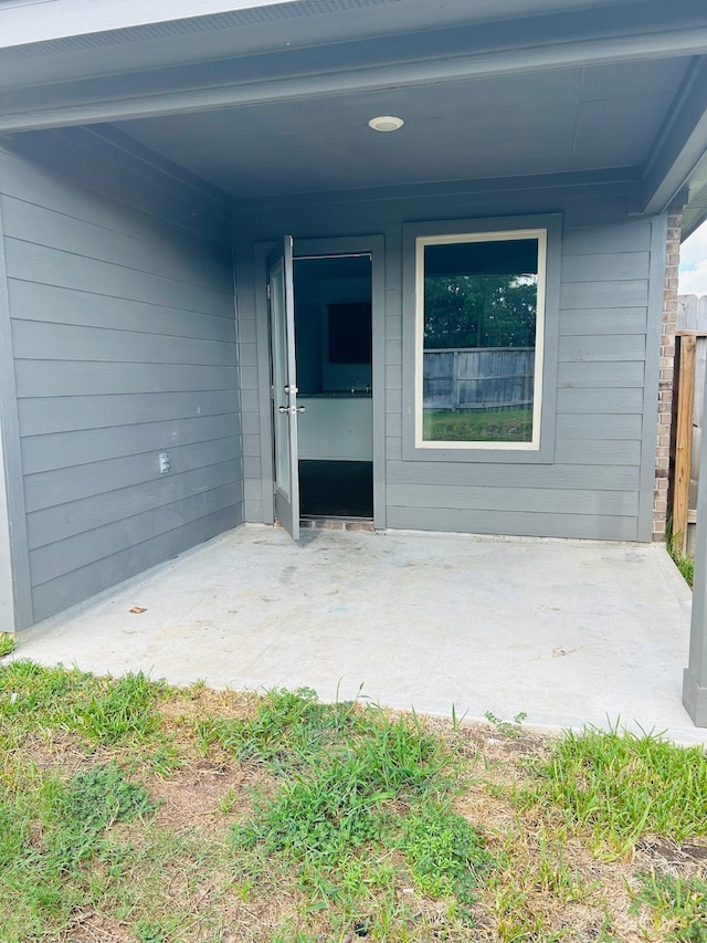 property entrance featuring a patio