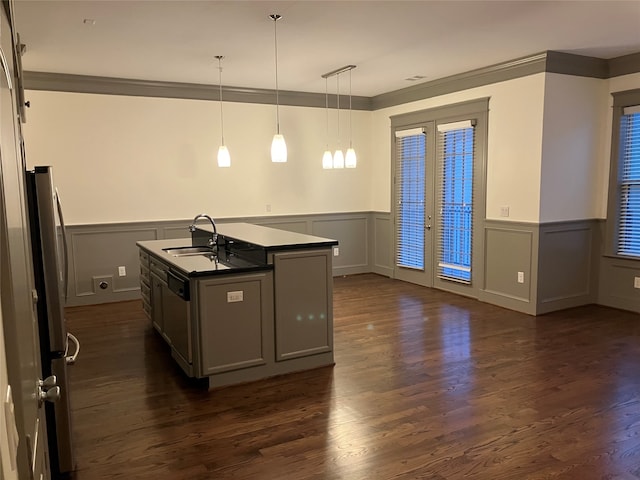 kitchen with hanging light fixtures, crown molding, dark hardwood / wood-style flooring, sink, and a kitchen island with sink