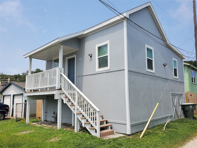 back of property featuring an outdoor structure and a yard