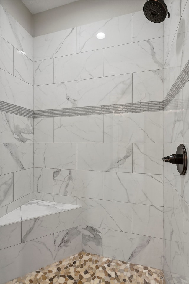 bathroom with a tile shower