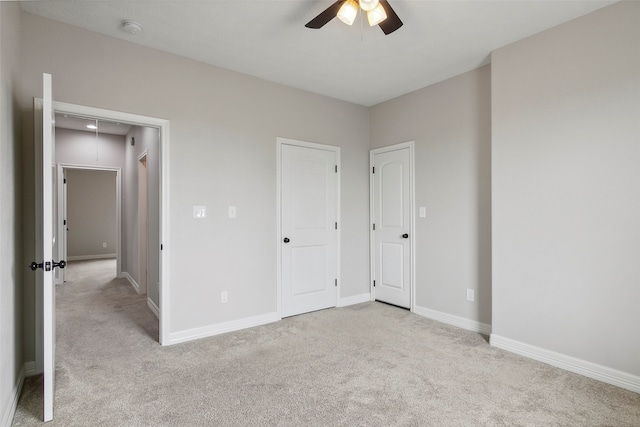 unfurnished bedroom with ceiling fan and light carpet