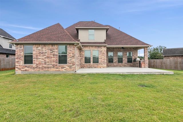 rear view of property with a lawn and a patio area