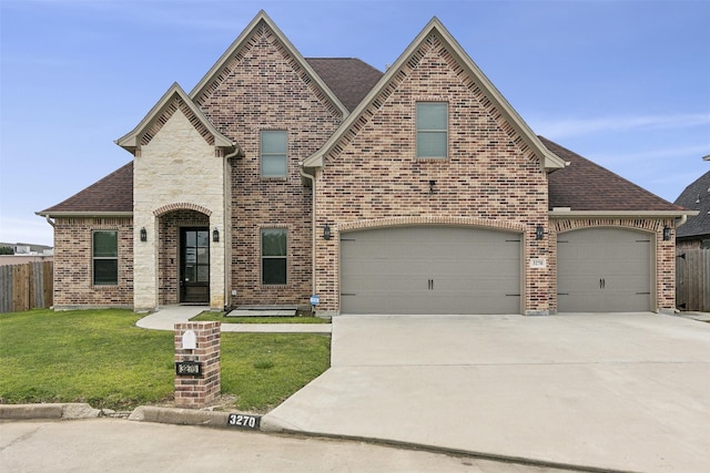 view of front of property with a garage and a front yard