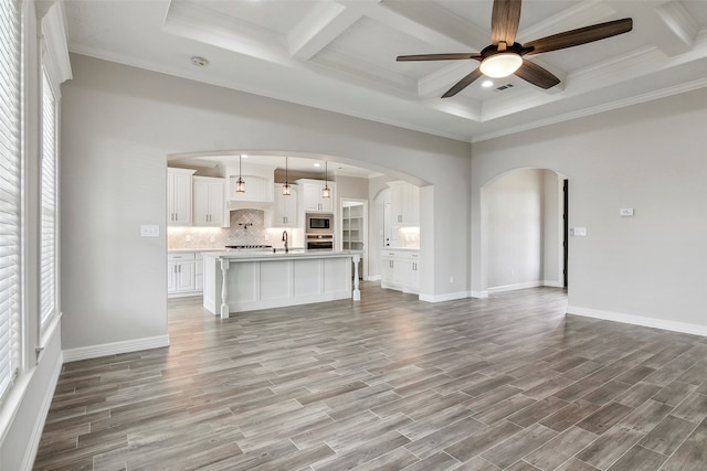 unfurnished living room featuring ceiling fan, coffered ceiling, and light hardwood / wood-style floors