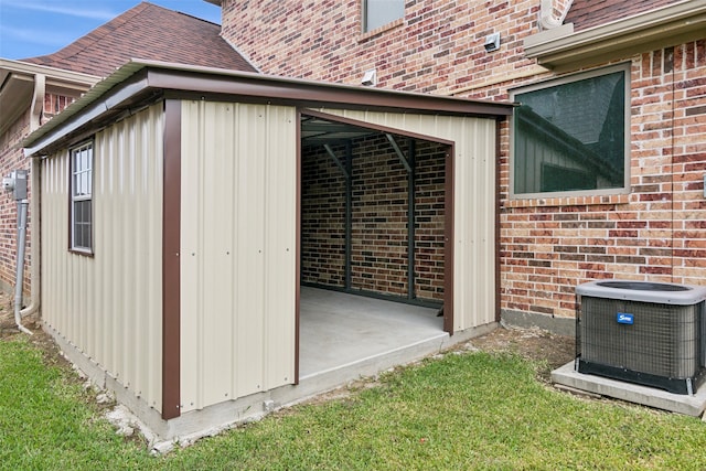 exterior space featuring a yard and central air condition unit