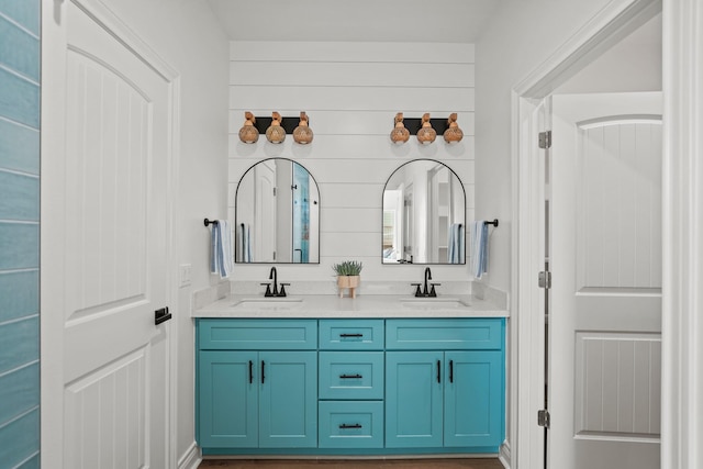 bathroom featuring vanity and wood walls