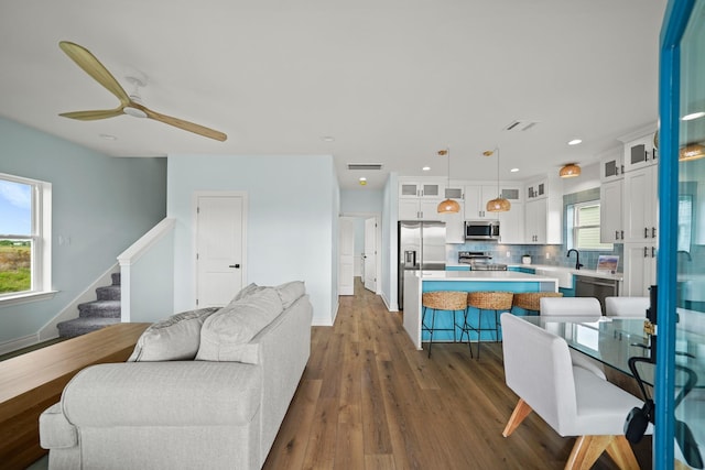 living room with sink, dark hardwood / wood-style floors, and ceiling fan