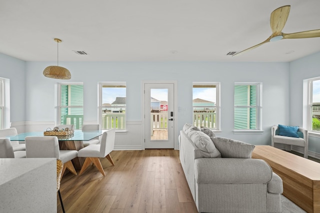 living room featuring ceiling fan and light wood-type flooring