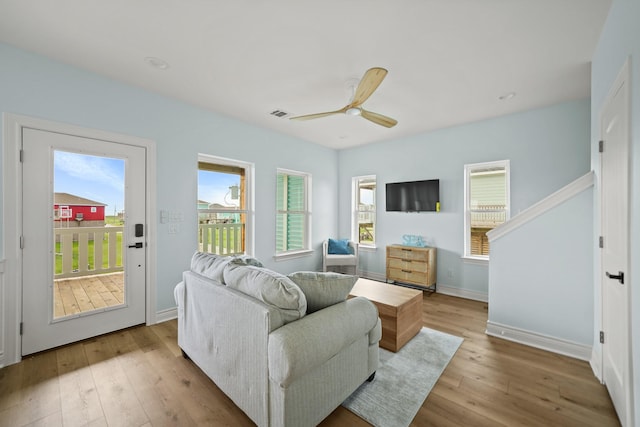 living room with ceiling fan and light hardwood / wood-style floors