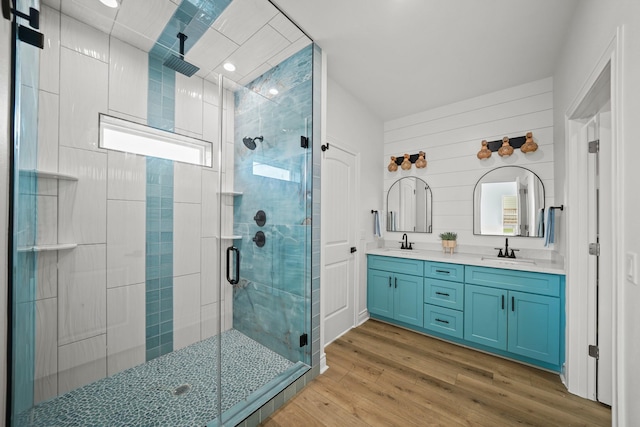 bathroom featuring vanity, wood-type flooring, and walk in shower