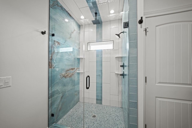 bathroom featuring a shower with shower door