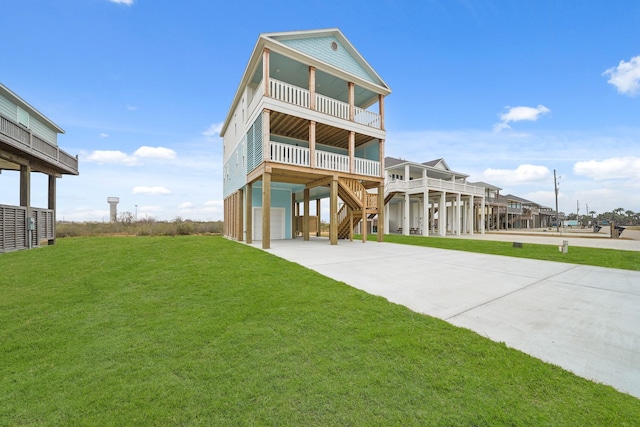 view of front facade featuring a balcony, a garage, covered porch, and a front yard