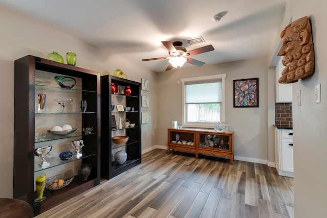 interior space with wood-type flooring and ceiling fan