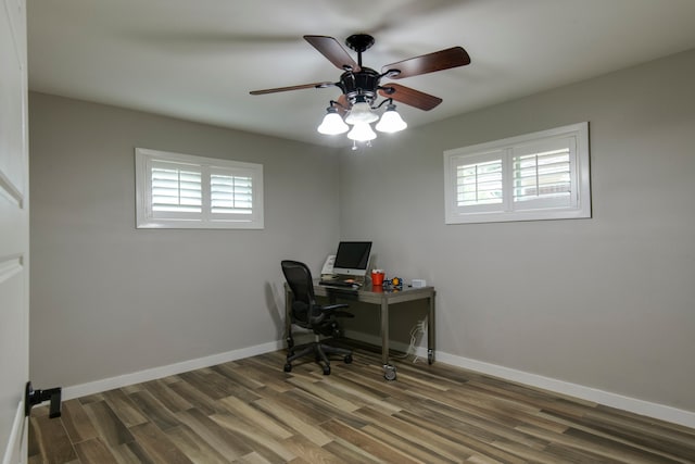 office with dark wood-type flooring and ceiling fan