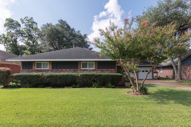 ranch-style house with a garage and a front lawn