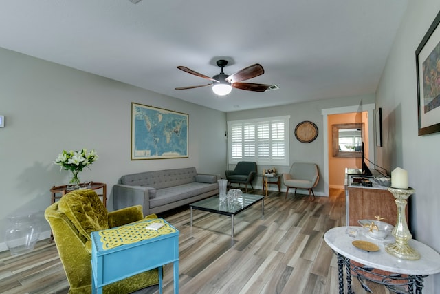 living room with ceiling fan and wood-type flooring