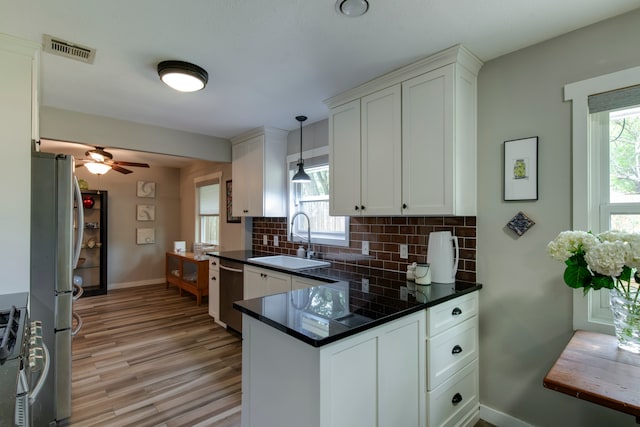 kitchen with plenty of natural light, decorative light fixtures, sink, and ceiling fan