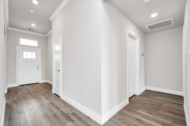 entryway with crown molding and hardwood / wood-style floors