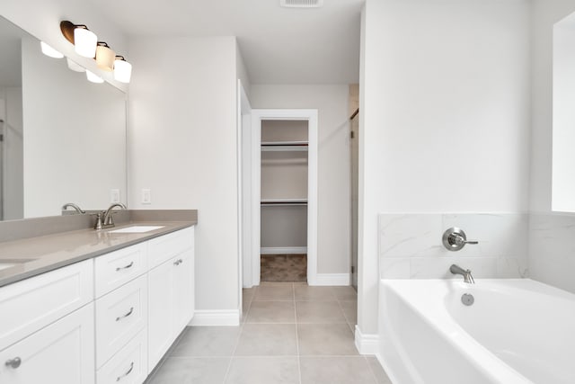 bathroom with tile patterned floors, shower with separate bathtub, and vanity