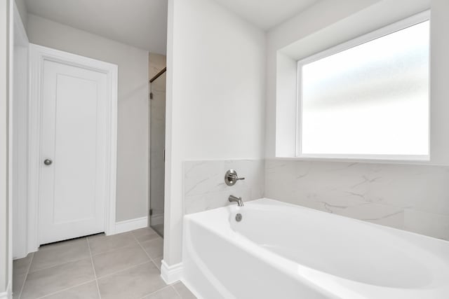 bathroom featuring plus walk in shower and tile patterned flooring