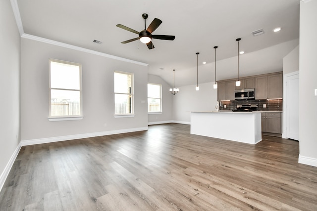 kitchen with ceiling fan with notable chandelier, appliances with stainless steel finishes, and wood-type flooring