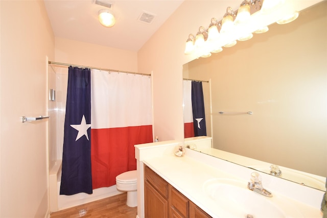 full bathroom featuring shower / bathtub combination with curtain, hardwood / wood-style floors, vanity, and toilet