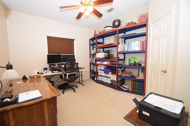 carpeted home office with ceiling fan