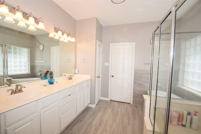 bathroom featuring shower with separate bathtub, vanity, and hardwood / wood-style flooring