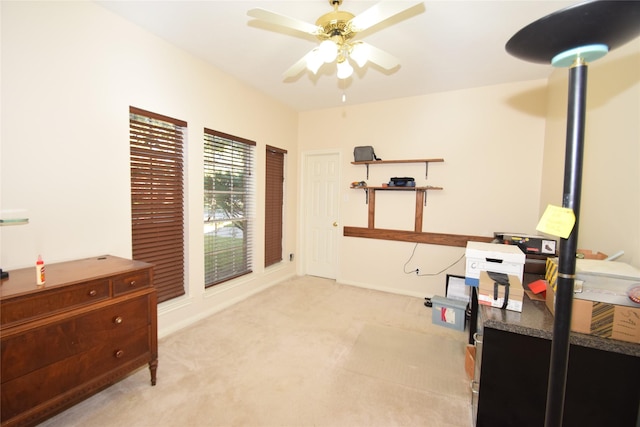 interior space featuring ceiling fan and light colored carpet