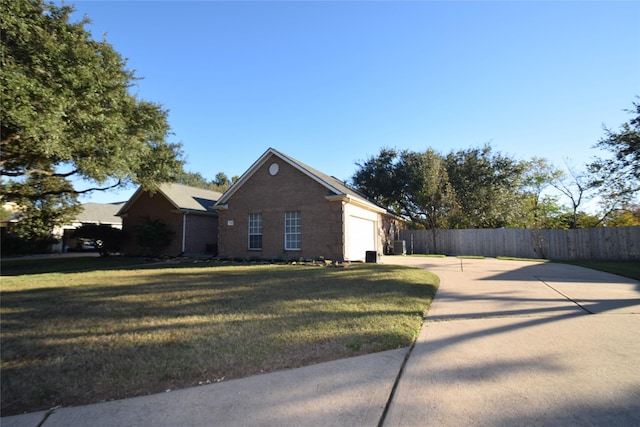 view of front of property featuring a garage and a front lawn