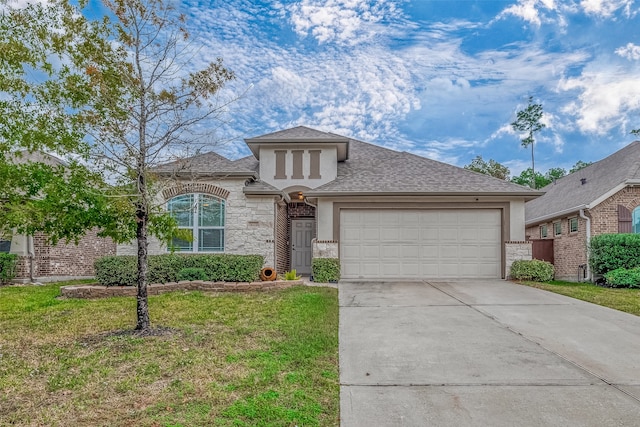 view of front of home with a front yard and a garage