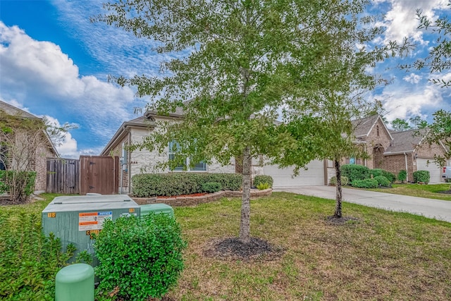 obstructed view of property with a front yard and a garage