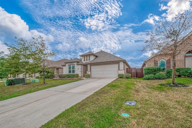 view of front of property with a garage and a front lawn