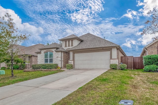 view of front of property featuring a garage and a front lawn