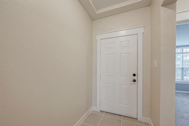 doorway to outside with light tile patterned floors