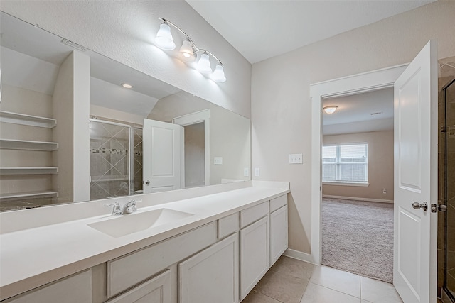 bathroom with tile patterned flooring, vanity, a shower with shower door, and vaulted ceiling