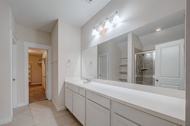 bathroom featuring tile patterned flooring, vanity, and an enclosed shower