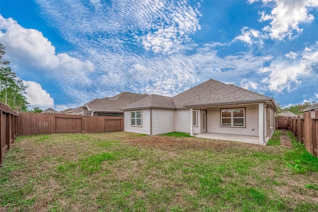 back of property featuring a yard and a patio