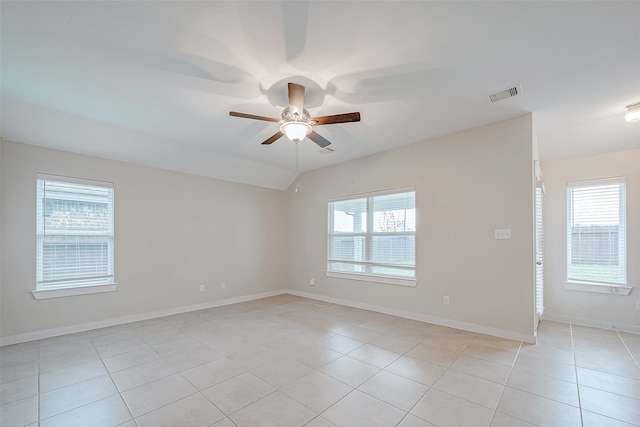 tiled empty room featuring plenty of natural light and ceiling fan