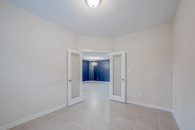 tiled spare room with french doors