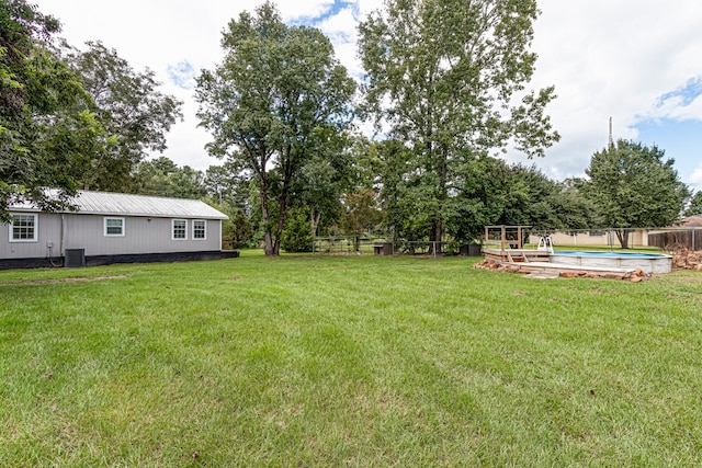 view of yard with a fenced in pool