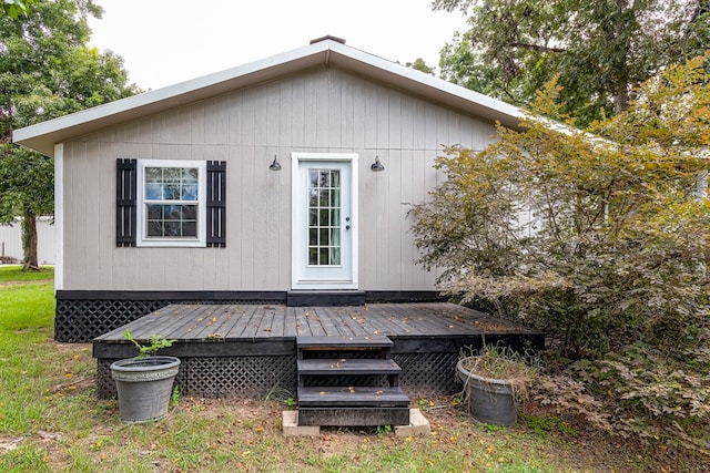 rear view of property with a wooden deck