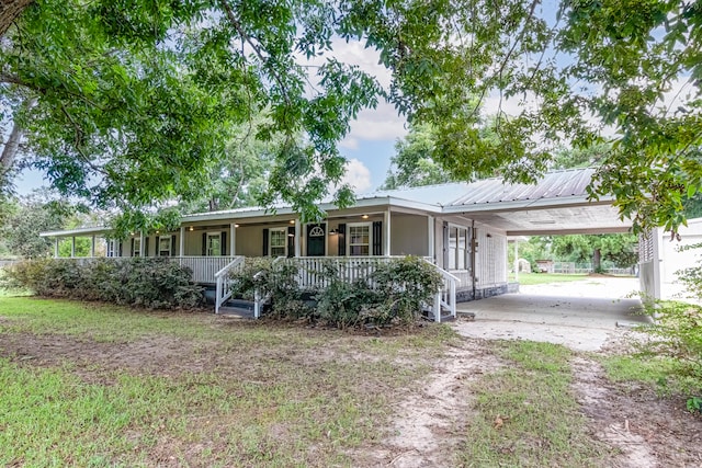 ranch-style home featuring covered porch and a carport