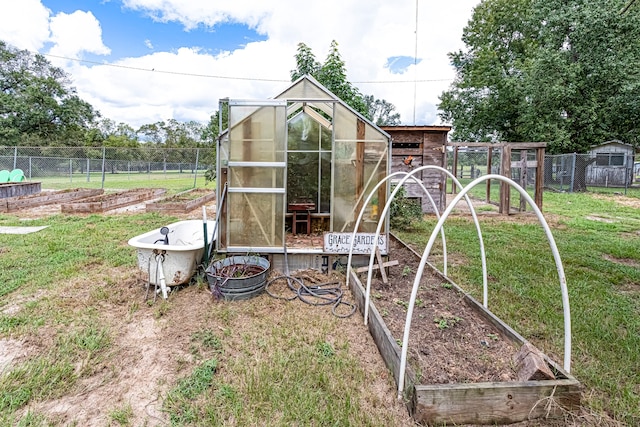 view of play area with an outdoor structure and a lawn