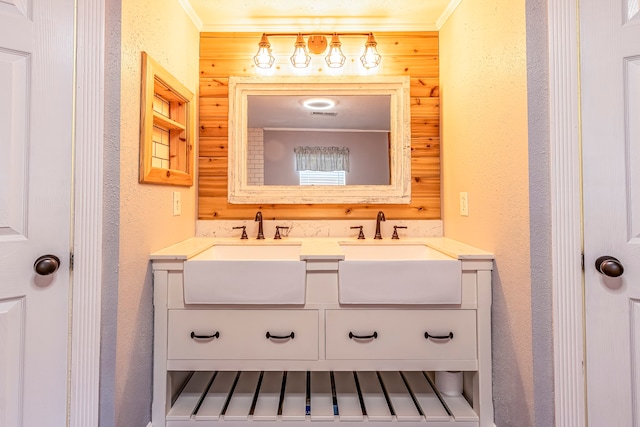 bathroom with crown molding, vanity, and wood walls