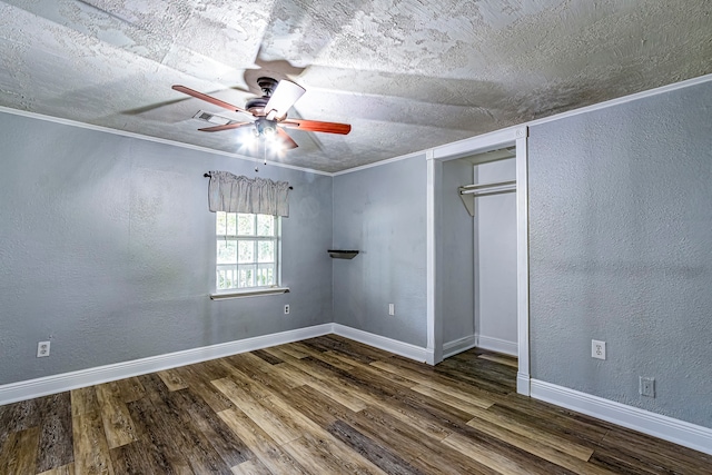 empty room featuring a textured ceiling, ceiling fan, and dark hardwood / wood-style flooring