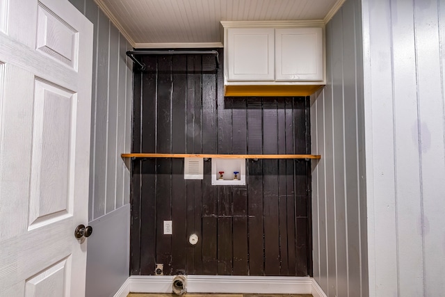 laundry area featuring wooden walls, cabinets, crown molding, hookup for an electric dryer, and washer hookup