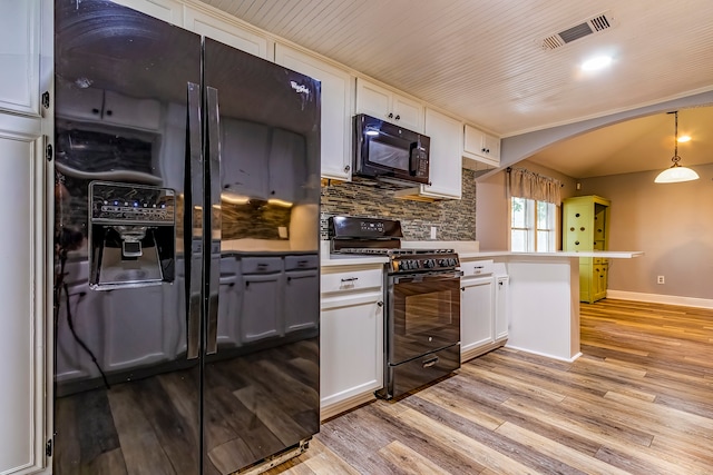 kitchen with black appliances, pendant lighting, light hardwood / wood-style flooring, kitchen peninsula, and white cabinets