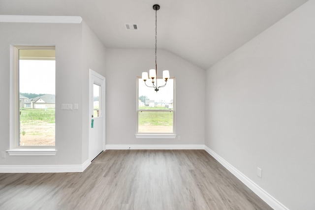 unfurnished dining area featuring wood finished floors, visible vents, plenty of natural light, and an inviting chandelier